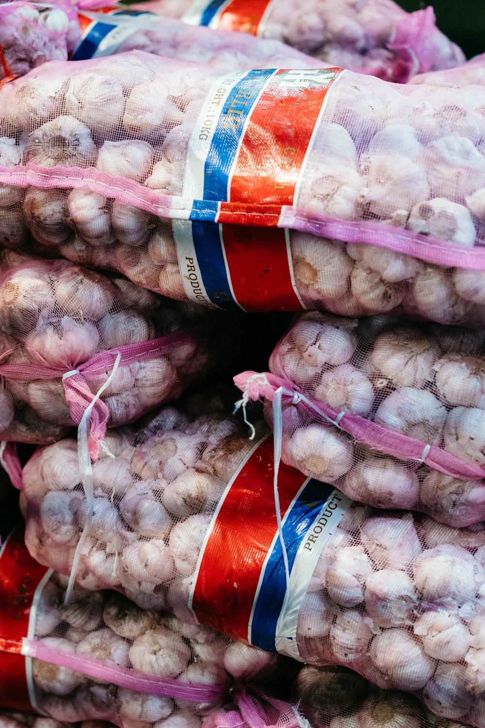 Fresh garlic beside wholesale produce sacks